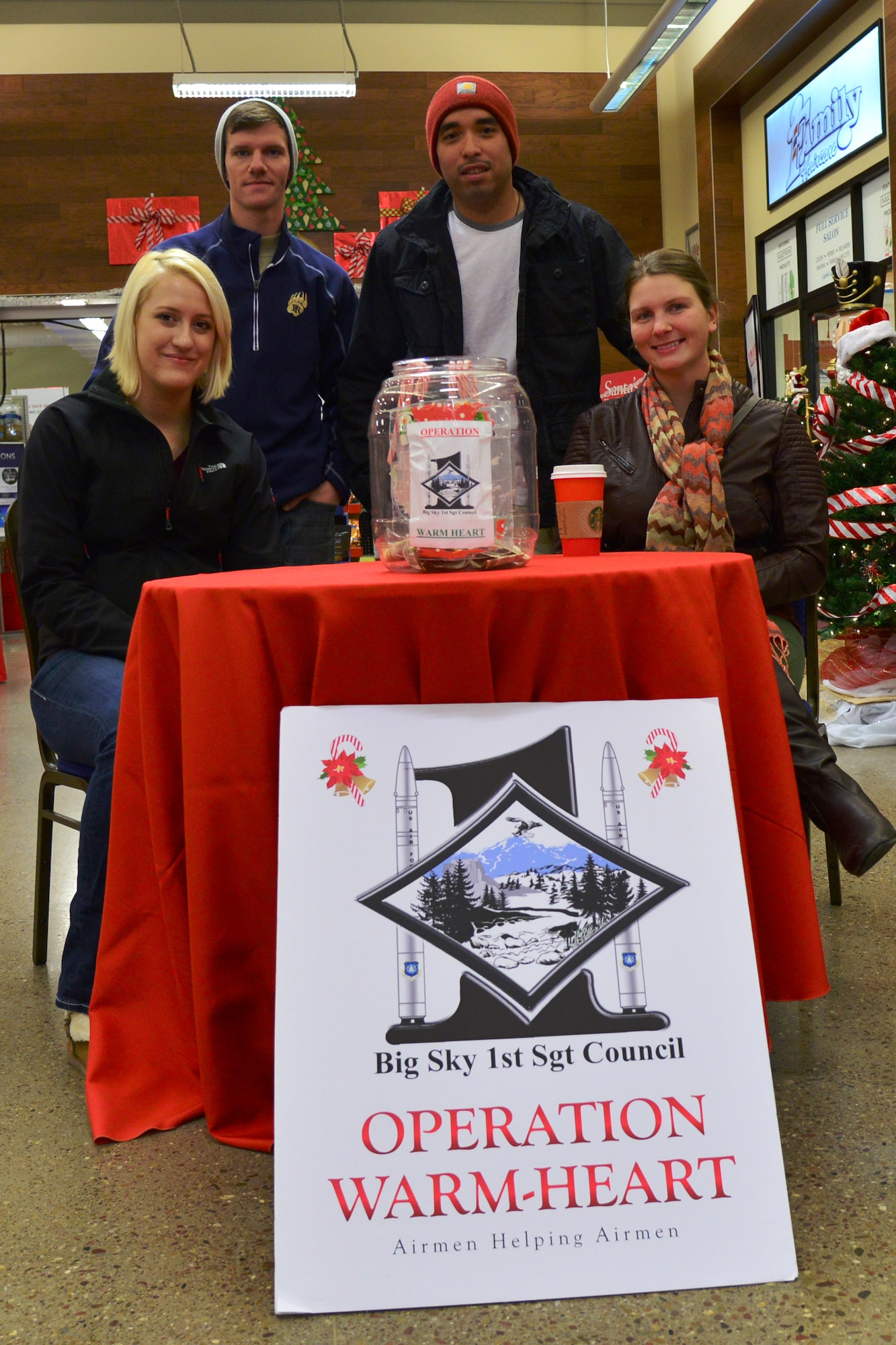 Airmen raise money at the Base Exchange for Operation Warm-Heart Nov. 24, 2015, at Malmstrom Air Force Base, Mont. Since October 2013, Operation Warm-Heart has supported more than 300 Malmstrom Airmen and their families. (U.S. Air Force photo/Airman Daniel Brosam)