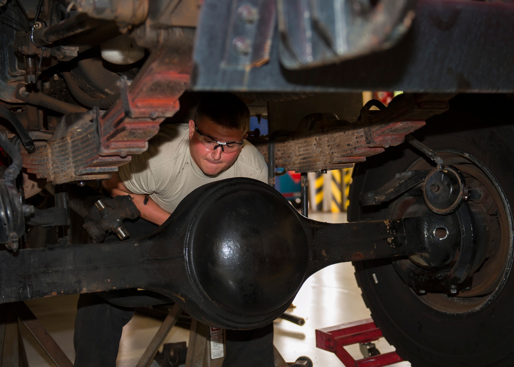 Airman 1st Class Thomas Zak, 96th Logistics Readiness Squadron, removes the hardware from the damaged differential component from Tanker 46 Nov. 10 at Eglin Air Force Base, Fla. The part was procured from a Tyndall AFB fire truck slated for the salvage yard and re-installed into the broken 1989 model 2,000 gallon water tanker fire truck. The repair job saved the Wing $25 thousand and maintained response readiness. (U.S. Air Force photo/Ilka Cole)