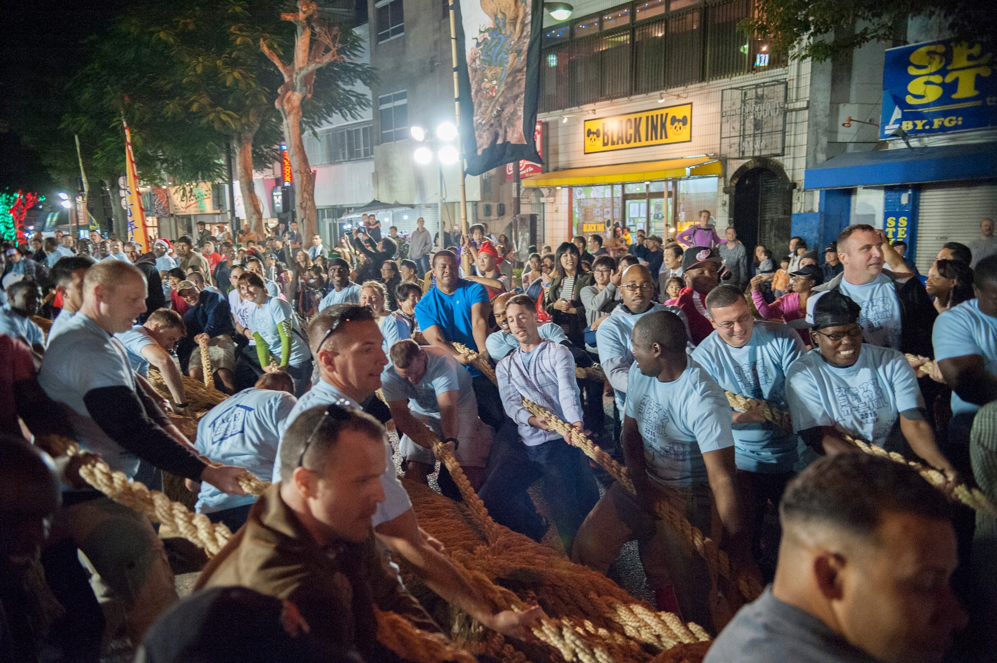Americans and Japanese work side-by-side during the tug-of-war competition, Nov. 28, 2015, at the Okinawa International Carnival. Approximately 25,000 people attended the annual event, which highlights Okinawa City's international culture. (U.S. Air Force photo by Master Sgt. Jason W. Edwards)