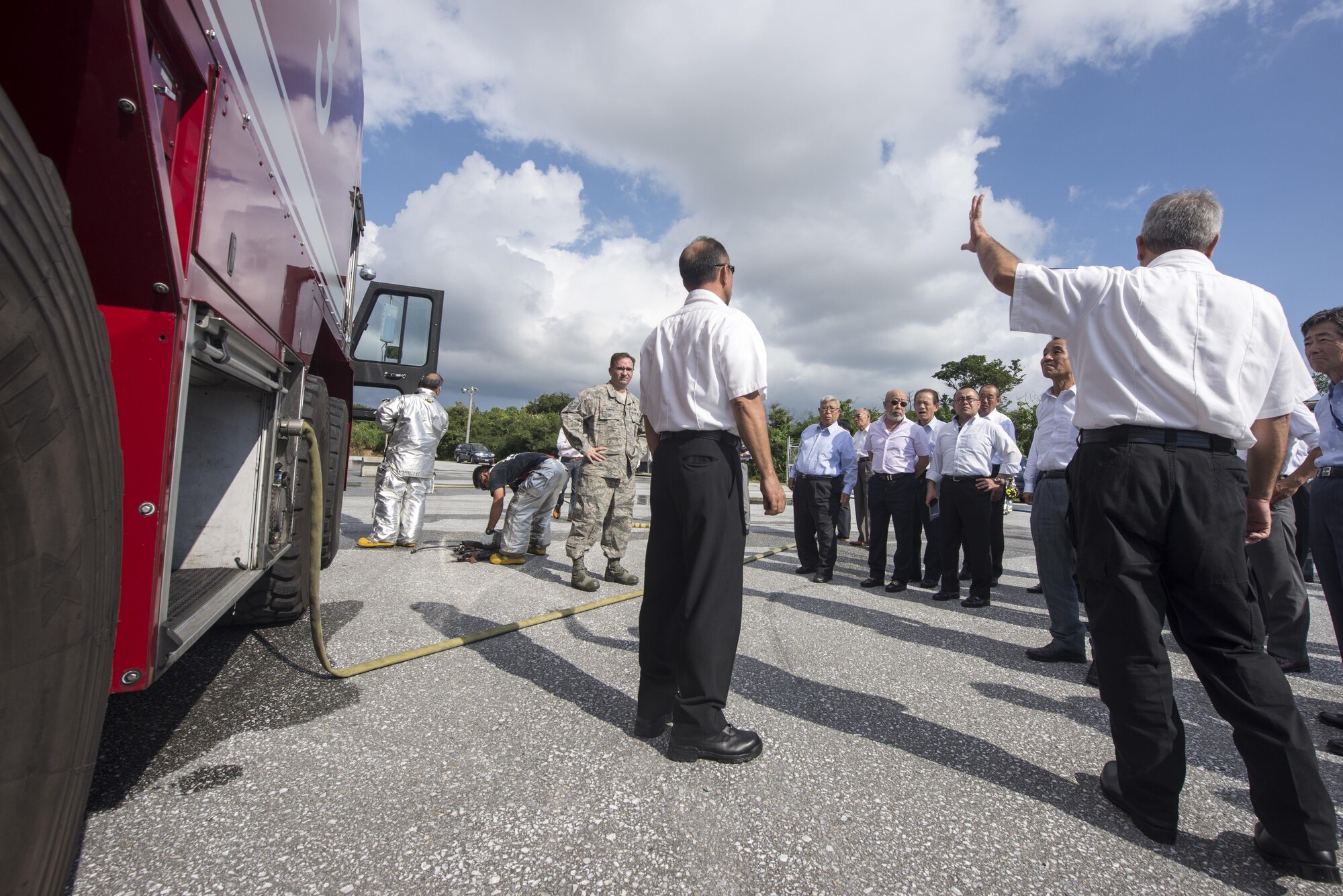 Kadena firefighters show firefighter cadets from Tokyo and Okinawa the different types of equipment they use in the event of an emergency, Nov. 24, 2015, at Kadena Air Base, Japan. The 18th Civil Engineer Group conducted a live-fire training demonstration as a way to increase relations and response effectiveness between the Japanese community and U.S. forces in the event of an emergency. (U.S. Air Force photo by Senior Airman Omari Bernard)
