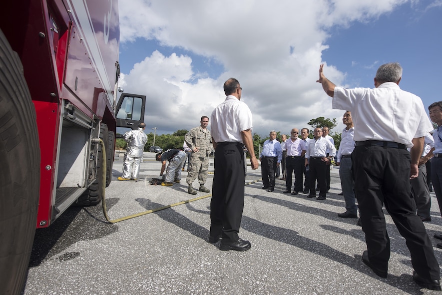 Kadena firefighters show firefighter cadets from Tokyo and Okinawa the different types of equipment they use in the event of an emergency, Nov. 24, 2015, at Kadena Air Base, Japan. The 18th Civil Engineer Group conducted a live-fire training demonstration as a way to increase relations and response effectiveness between the Japanese community and U.S. forces in the event of an emergency. (U.S. Air Force photo by Senior Airman Omari Bernard)