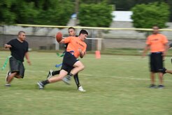 A U.S. Air Force member runs with a football during the annual Turkey Bowl, Army vs. Air Force, at Soto Cano Air Base, Honduras, Nov. 25, 2015. (U.S. Air Force photo by Martin Chahin/Released)