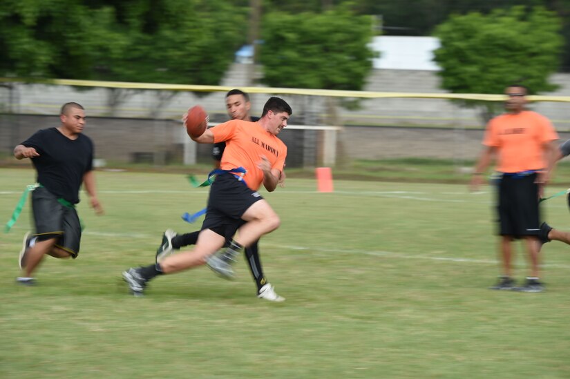 A U.S. Air Force member runs with a football during the annual Turkey Bowl, Army vs. Air Force, at Soto Cano Air Base, Honduras, Nov. 25, 2015. (U.S. Air Force photo by Martin Chahin/Released)