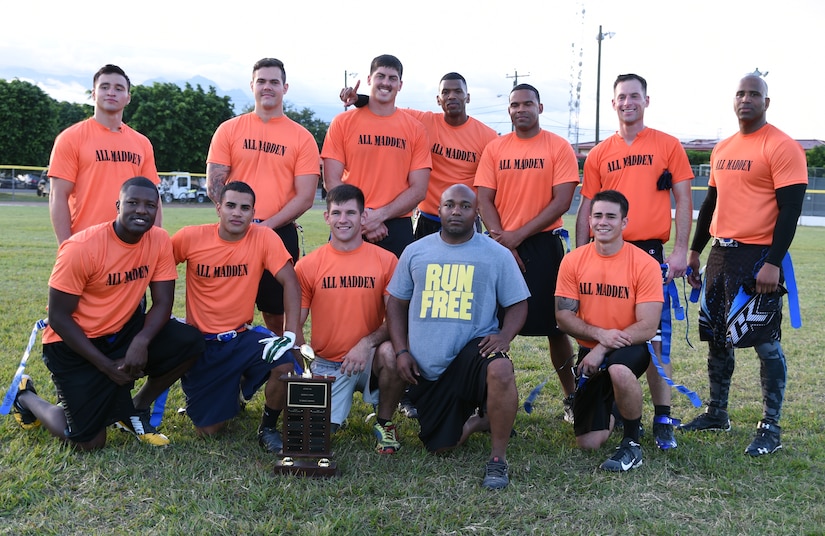 U.S. Air Force members pose for a celebration photo after winning the annual Turkey Bowl, Army vs. Air Force, at Soto Cano Air Base, Honduras, Nov. 25, 2015. (U.S. Air Force photo by Martin Chahin/Released)