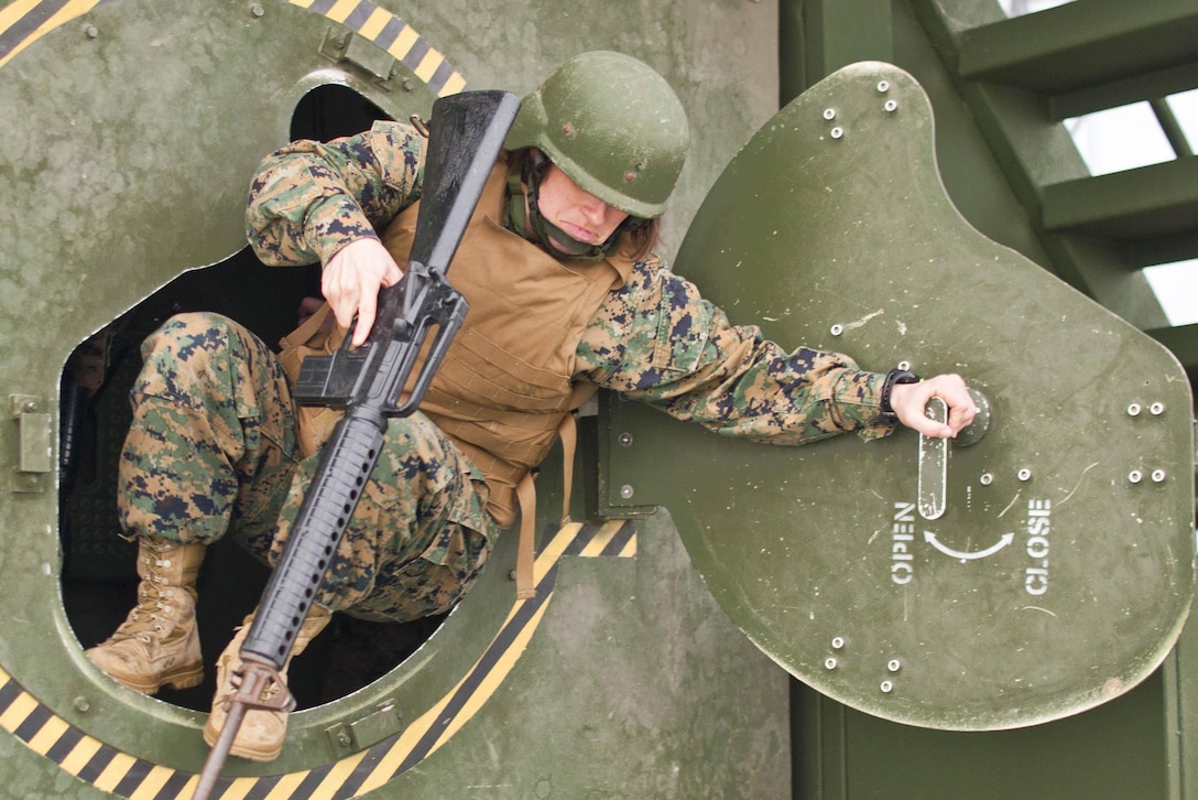 Marine Corps Capt. Ericka Johnson conducts egress training on the Quantico Reserve Support Unit Humvee Egress Assistance Trainer on Marine Corps Base Quantico, Va., Nov. 20, 2015. The training replicates the effort required to exit an overturned vehicle. Johnson is a Legal Service Support Section defense attorney. U.S. Marine Corps photo