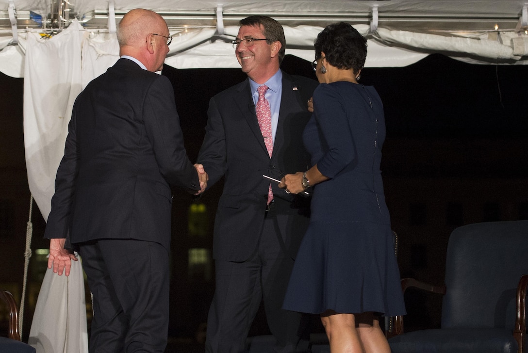 Defense Secretary Ash Carter shakes hands with Klaus Schwab, founder and executive chairman of the World Economic Forum after he and Commerce Secretary Penny Pritzker participated in a moderated conversation hosted by Schwab during the World Economic Forum dinner held at the Pentagon, Sept. 30, 2015. DoD photo by Air Force Senior Master Sgt. Adrian Cadiz