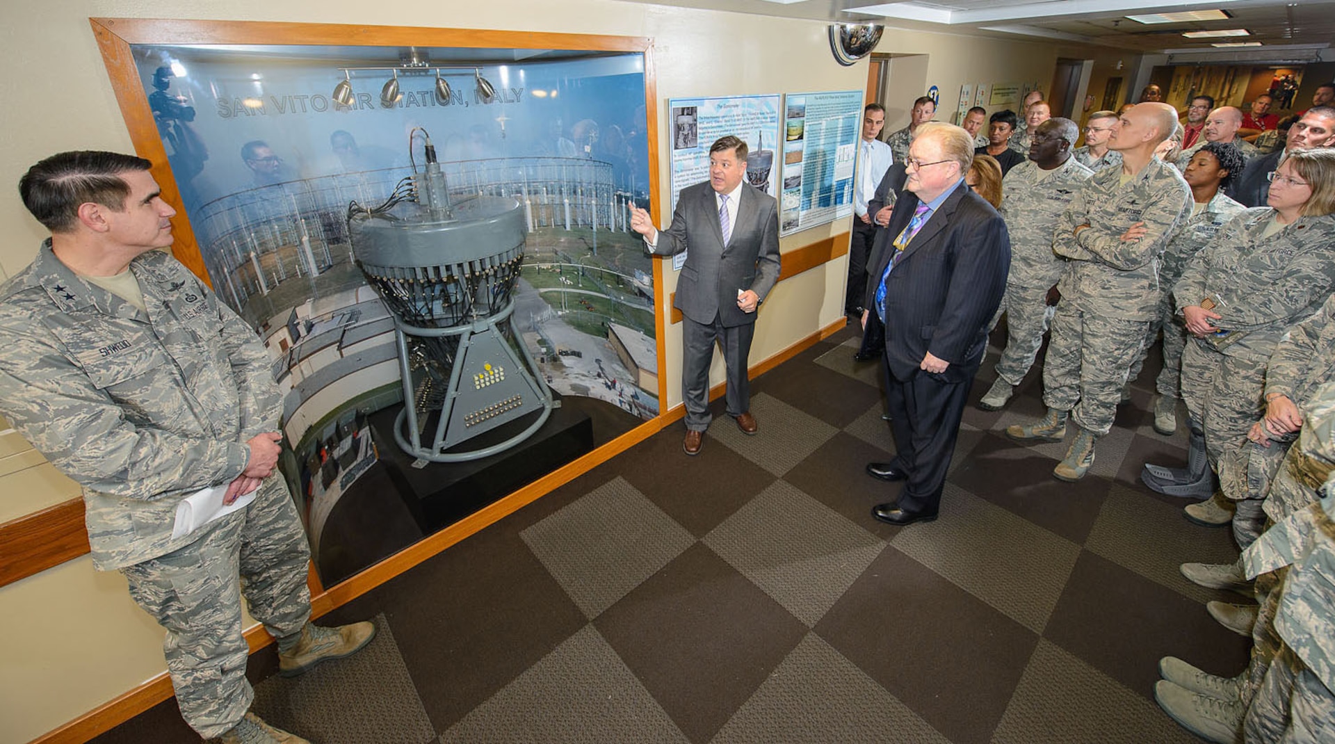 Mr. Gabriel Marshall, 25th Air Force directorate of history and research, explains the function of the goniometer to Maj. Gen. Bradford J. (BJ) Shwedo, 25th AF commander, and the crowd of Airmen during the unveiling ceremony September 25 in the main hallway of Bldg. 2000, Joint Base San Antonio-Lackland, Texas. (U.S. Air Force photo by William B. Belcher/released)
