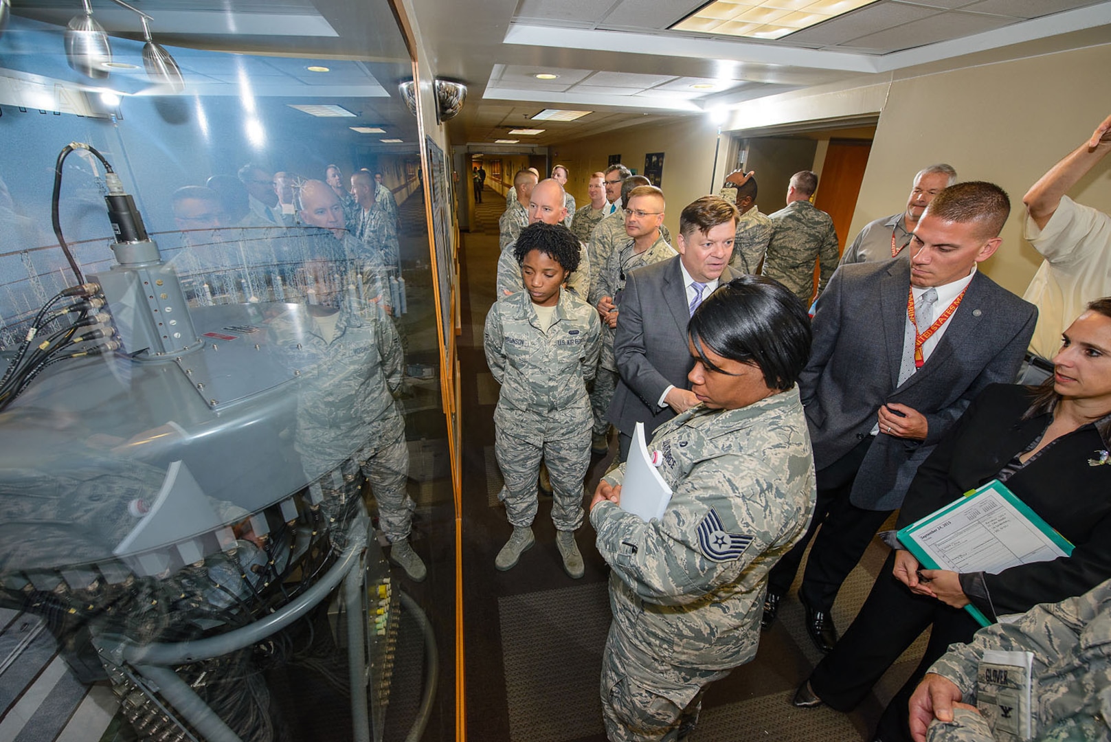 Mr. Gabriel Marshall, 25th Air Force directorate of history and research, fields questions and explains the function of the goniometer to Airmen attending the unveiling ceremony Sept. 25 in the main hallway of Bldg. 2000 at Joint Base San Antonio-Lackland, Texas. (U.S. Air Force photo by William B. Belcher/released)