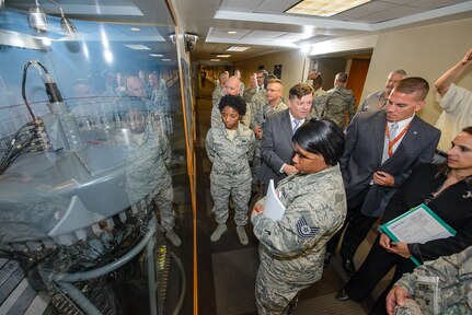 Mr. Gabriel Marshall, 25th Air Force directorate of history and research, fields questions and explains the function of the goniometer to Airmen attending the unveiling ceremony Sept. 25 in the main hallway of Bldg. 2000 at Joint Base San Antonio-Lackland, Texas. (U.S. Air Force photo by William B. Belcher/released)