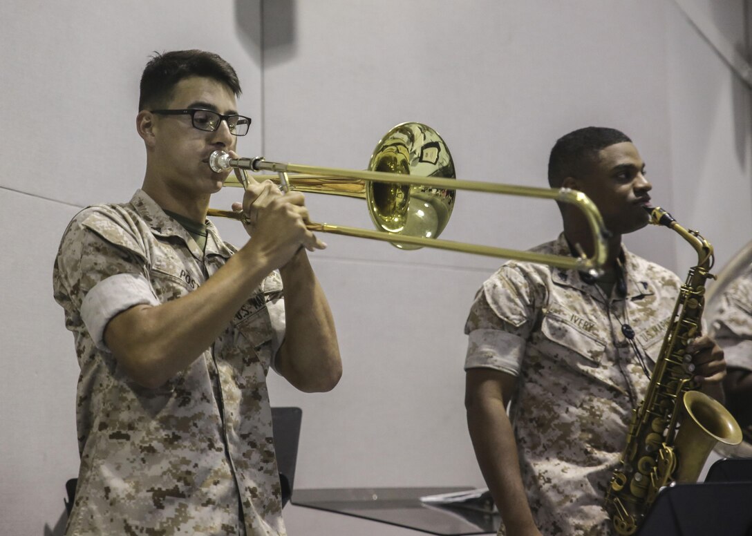 Lance Cpl. Jacob S. Post, a trombonist player with the 2nd Marine Division Band, plays for Amber N. Carter, a resident of Hubert, N.C., during her visit to the band’s command post at Camp Lejeune, N.C., Sept. 29, 2015. Amber always dreamed of joining the Marine Corps, but could not due to William’s syndrome. Staff Sgt. Isaiah Riley, a mess chief with 10th Marine Regiment, brought her and her family aboard the base to watch the band play. (U.S. Marine Corps photo by Cpl. Paul S. Martinez/Released)