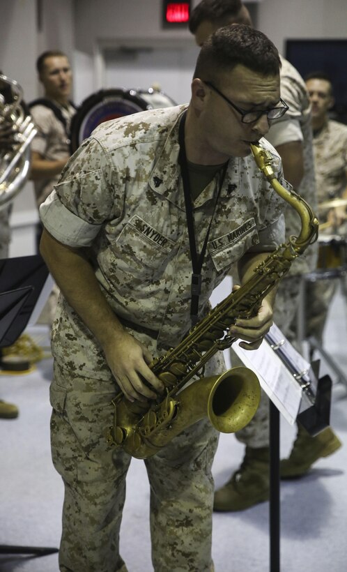 Cpl. Codie N. Snyder, a saxophonist with the 2nd Marine Division Band, plays for Amber N. Carter, a resident of Hubert, N.C., during her visit to the band’s command post at Camp Lejeune, N.C., Sept. 29, 2015. Amber always dreamed of joining the Marine Corps, but could not due to William’s syndrome. Staff Sgt. Isaiah Riley, a mess chief with 10th Marine Regiment, brought her and her family aboard the base to watch the band play. (U.S. Marine Corps photo by Cpl. Paul S. Martinez/Released)