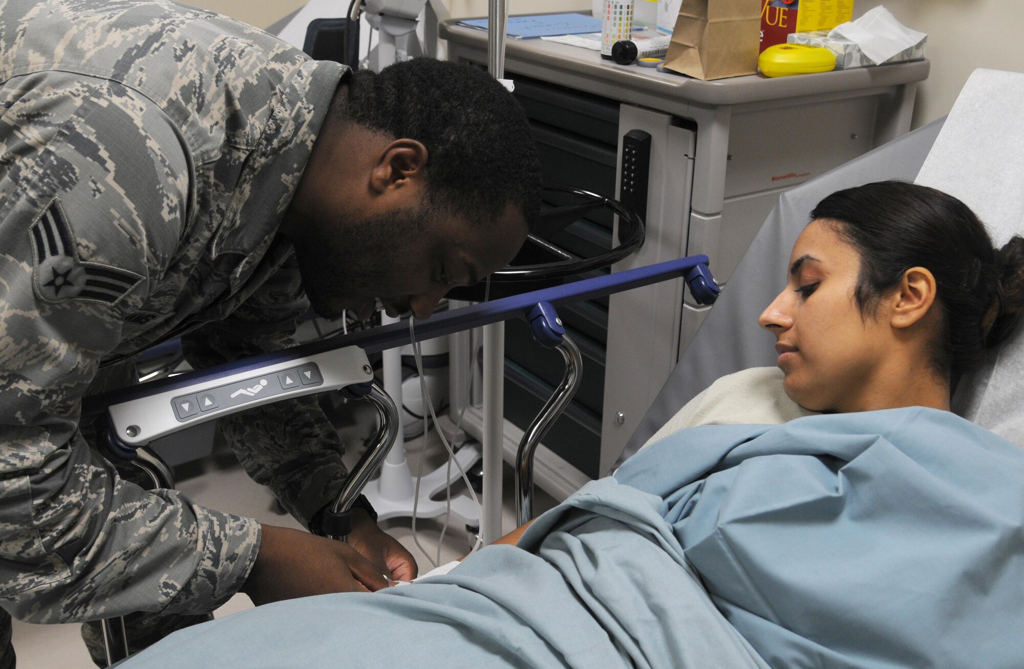 Senior Airman Jarrett Williams, 81st Aerospace Medicine Squadron medical technician, checks the IV of Senior Airman Raven Lopez-Holguin, 81st AMDS public health technician, at the student health clinic, Sept. 30, 2015, Keesler Air Force Base, Miss. The student health clinic is placed in the 81st Training Group area so services like physical therapy, mental health, sick hall and regular checkups are readily accessible to technical school students and clinic personnel. (U.S. Air Force photo by Senior Airman Holly Mansfield)