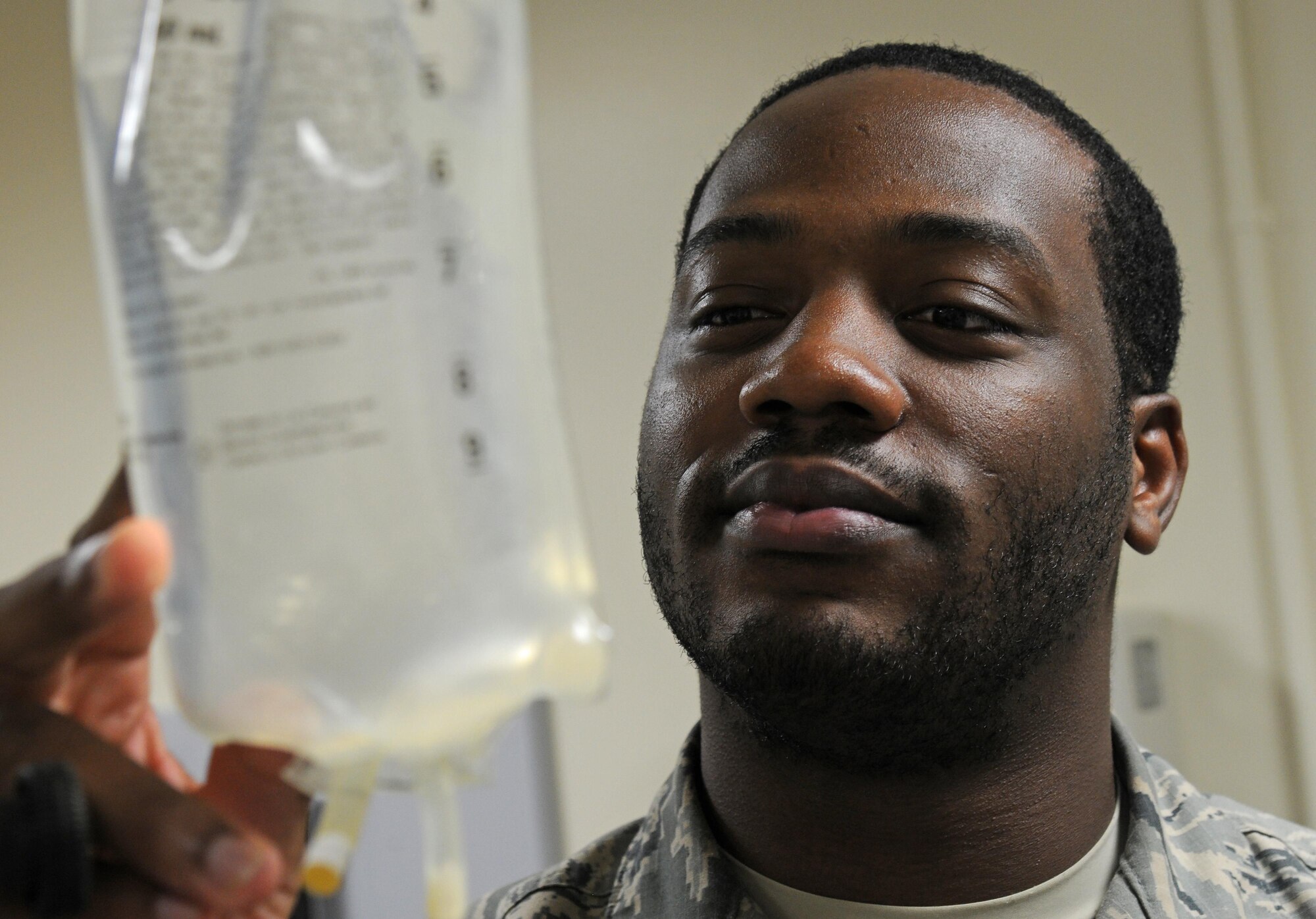 Senior Airman Jarrett Williams, 81st Aerospace Medicine Squadron medical technician, checks a patient’s IV bag during treatment at the student health clinic, Sept. 30, 2015, Keesler Air Force Base, Miss. The student health clinic is placed in the 81st Training Group area so services like physical therapy, mental health, sick hall and regular checkups are readily accessible to technical school students and clinic personnel. (U.S. Air Force photo by Senior Airman Holly Mansfield)