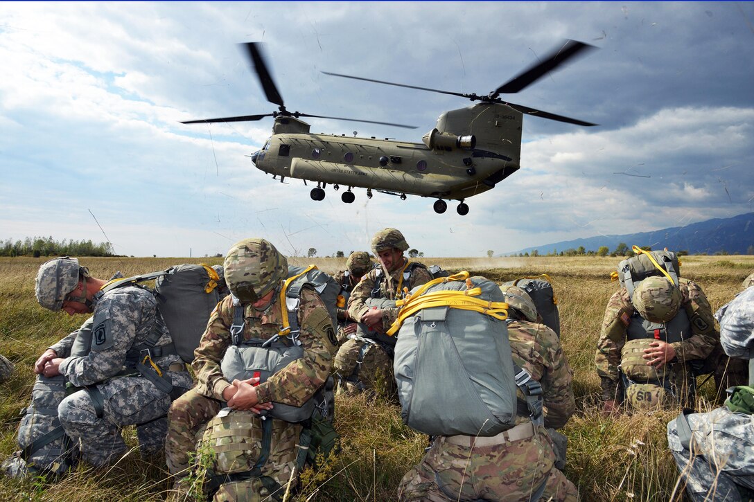 Paratroopers prepare to board a U.S. Army CH-47 Chinook helicopter for an airborne operation at Juliet drop zone in Pordenone, Italy, Sept. 30, 2015. The paratroopers are assigned to the 173rd Brigade Support Battalion, 173rd Airborne Brigade. U.S. Army photo by Paolo Bovo
