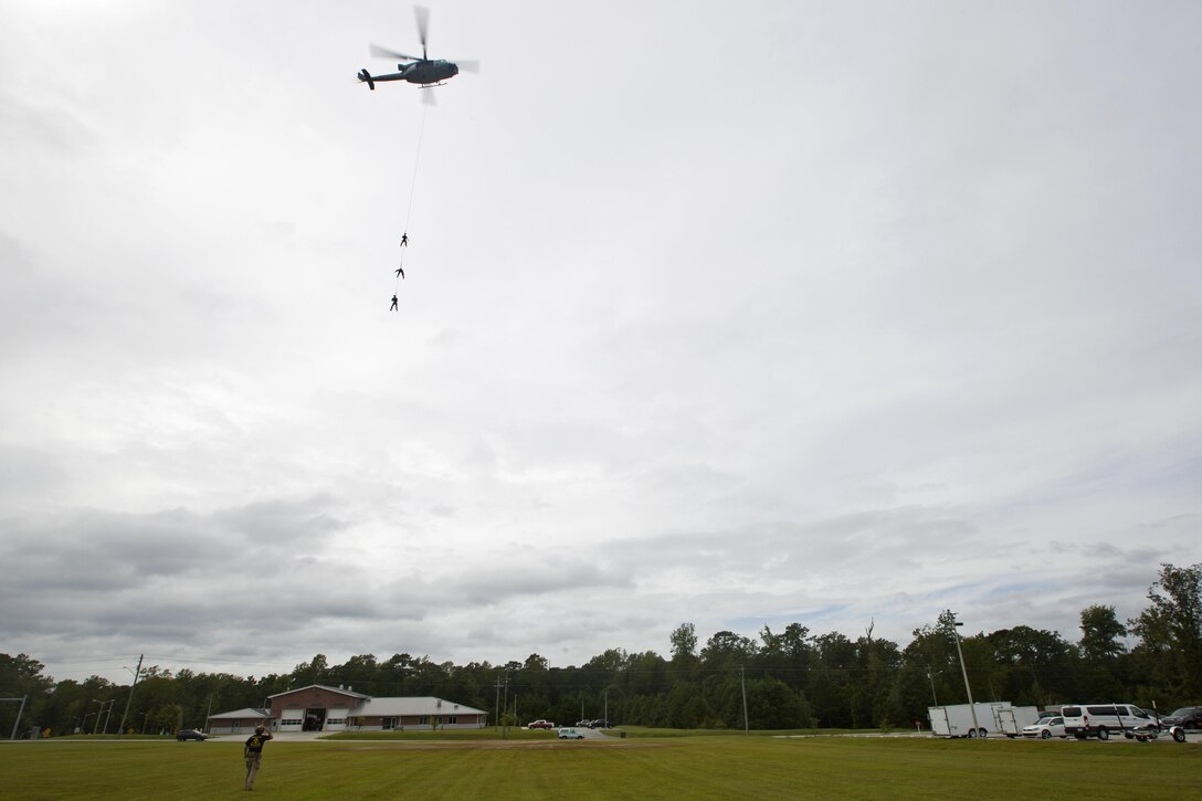 A UH-1Y helicopter lifts Marines during special patrol insertion and extraction training at Stone Bay on Marine Corps Base Camp Lejeune, N.C., Sept. 23, 2015. The helicopter crew is assigned to Marine Light Attack Helicopter Squadron 167, and the Marines are assigned to Marine Raider Regiment. The Marines flew from Marine Corps Air Station New River to assist MARSOC with the training. U.S. Marine Corps photo by Lance Cpl. Austin A. Lewis