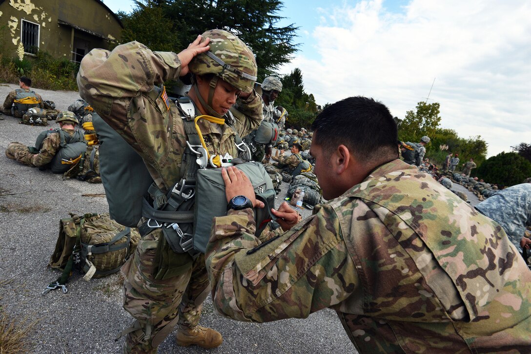 A jumpmaster inspects a paratrooper’s equipment before an airborne operation from a U.S. Army CH-47 Chinook helicopter at Juliet drop zone in Pordenone, Italy, Sept. 30, 2015. U.S. Army photo by Paolo Bovo