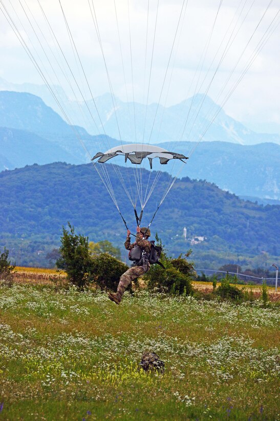 A paratrooper lands after a jump from a U.S. Army CH-47 Chinook helicopter at Juliet drop zone in Pordenone, Italy, Sept. 30, 2015. U.S. Army photo by Paolo Bovo