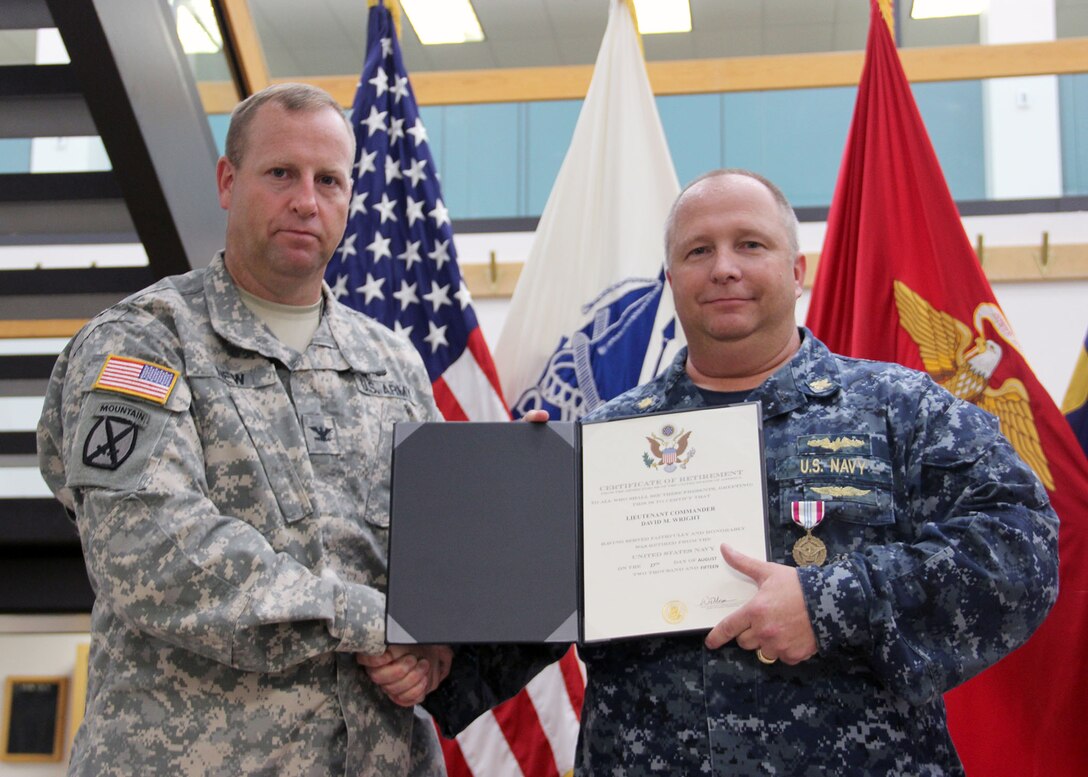 Navy Lt. Cmdr. Wright (right) is honored for his service at DLA Distribution Susquehanna, as Army Col. Corey New presents him with the Defense Meritorious Service Medal. Photo by Alex Wypijewski.