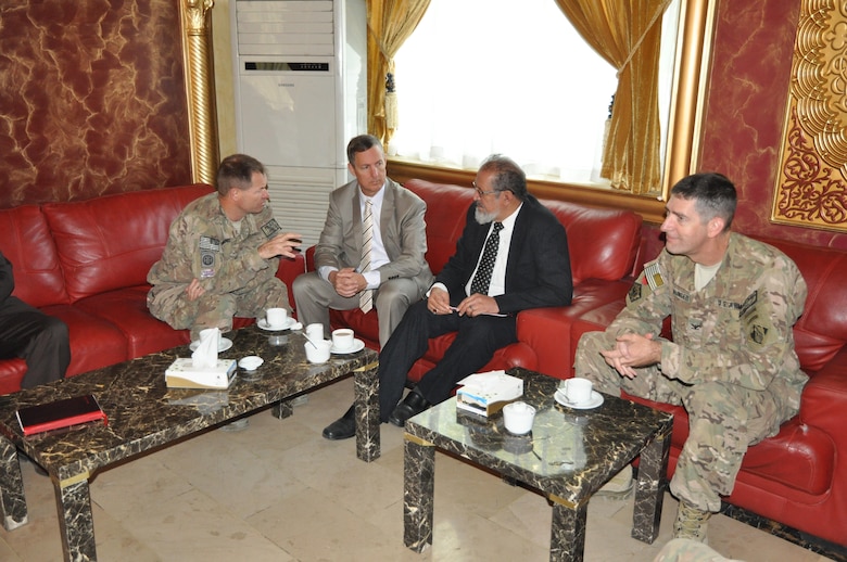 From left to right: Col. Fred Drummond, Gordon Simmons, Kabul's Deputy Mayor Zafar Khan and Col. Pete Helmlinger discuss traffic and infrastructure issues within the city of Kabul in October 2014.