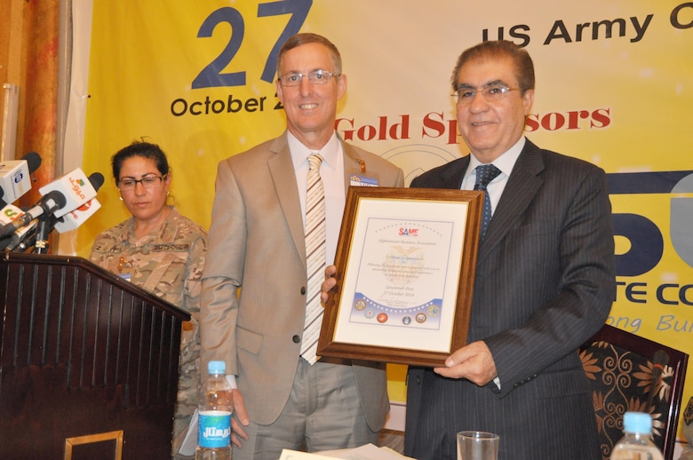 Savannah District's Chief of Engineering Gordon Simmons presents a plaque on behalf of the Savannah Society of American Military Engineers (SAME) to Mowdood Yassin, Afghanistan Builders Association president in October 2014. SAME purchased a set of American Society for Testing and Materials Standards enabling the Afghanistan Builders Association to perform laboratory validations to USACE standards.