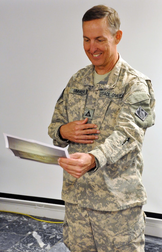 Savannah District's Chief of Engineering Gordon Simmons reads a going-away gift at his departure celebration in August 2015.