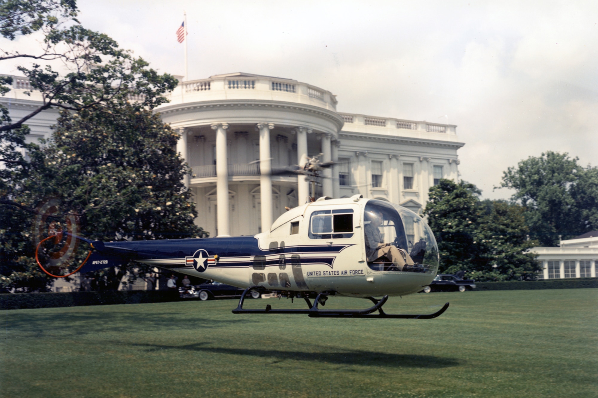 The UH-13J provided the president with quick and convenient air travel directly to and from the White House. The aircraft on display is shown landing on the West Lawn in 1957. (U.S. Air Force photo)