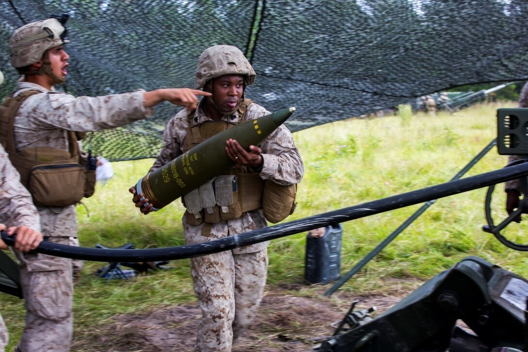 Sgt. Tony Frontenette, field artillery cannoneer with Lima Battery, 2nd Battalion, 10th Marine Regiment, carries a high-explosive round to be fired from an M777 Howitzer during a live-fire exercise at Camp Lejeune, N.C., Sept. 30, 2015. This was the last exercise Lima conducted as a standalone battery. (U.S. Marine Corps photo by Cpl. Kirstin Merrimarahajara/released)