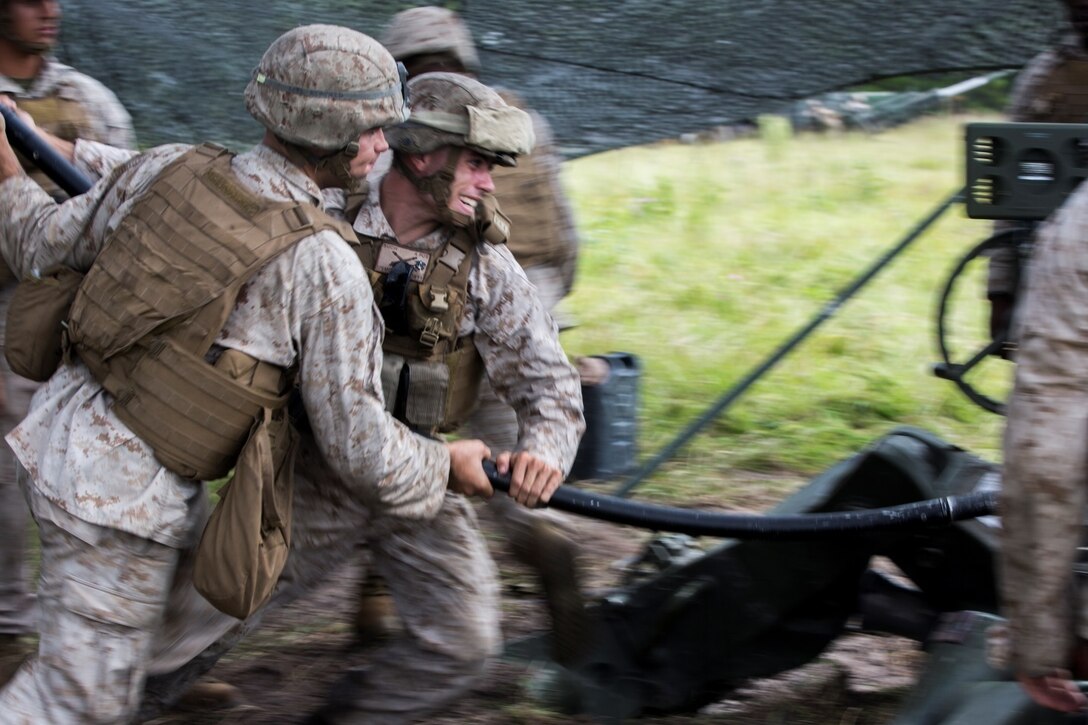 Cpl. Jesse Kincaid (left) and Lance Cpl. Brandon Such (right), field artillery cannoneers with Lima Battery, 2nd Battalion, 10th Marine Regiment, use a ramming rod to help fire an M777 Howitzer during a live-fire exercise at Camp Lejeune, N.C., Sept. 30, 2015. This was the last exercise Lima conducted as a standalone battery. (U.S. Marine Corps photo by Cpl. Kirstin Merrimarahajara/released)