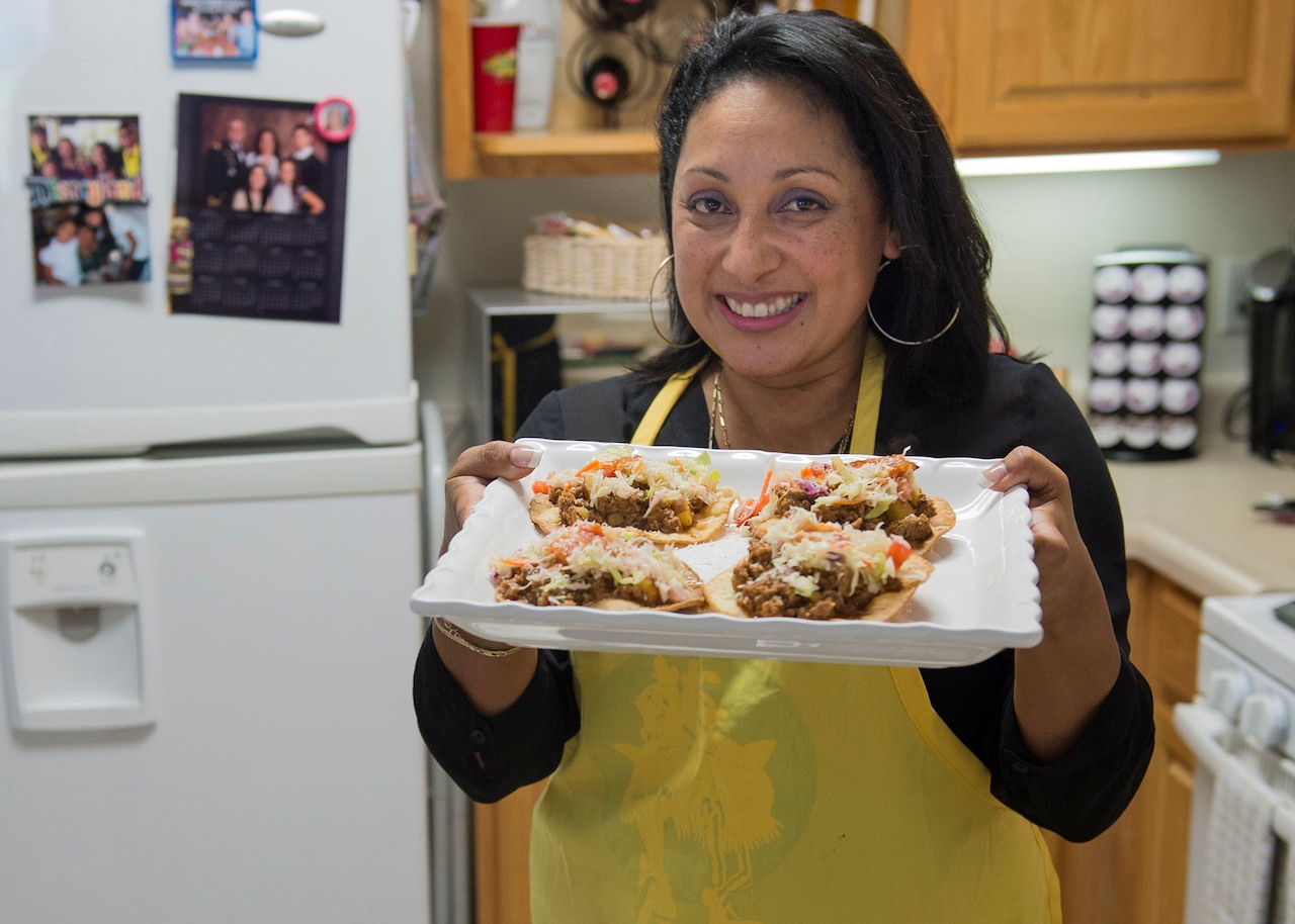 Jenny Lopez-Guerrero, wife of Army Capt. Daniel Lopez-Guerrero, shows off the traditional Honduran meal she prepared.