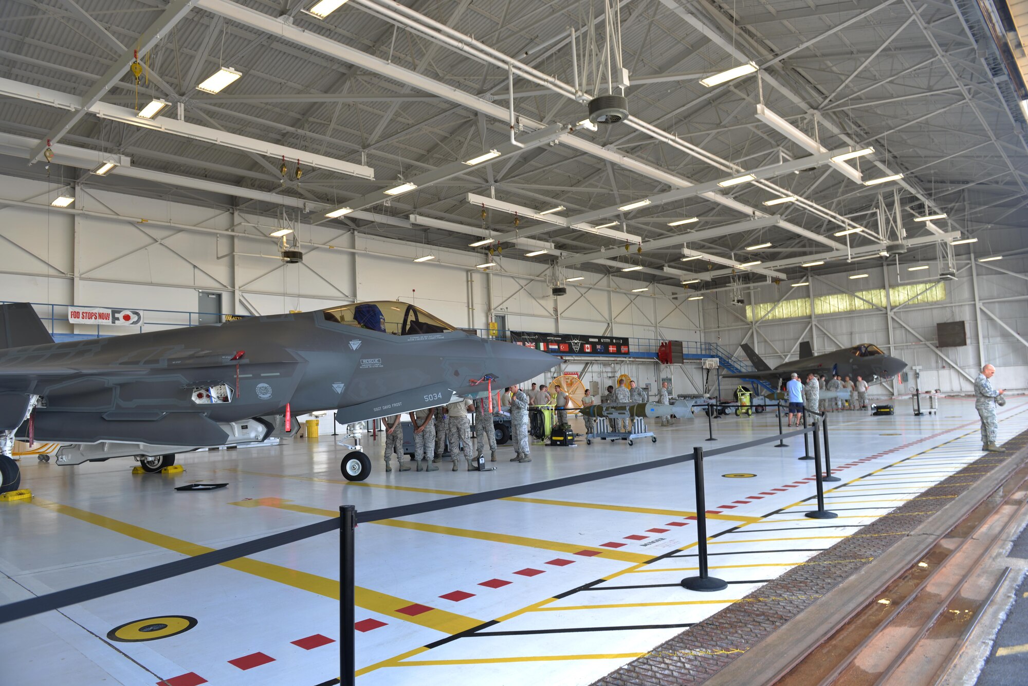 Members of the 33rd Aircraft Maintenance Squadron prepare to start a weapons load competition at Eglin Air Force Base, Fla., Sept. 30, 2015. Airmen compete to determine which team is the best F-35A Lightning II weapons load crew team. (U.S. Air Force Photo/Senior Airman Andrea Posey)