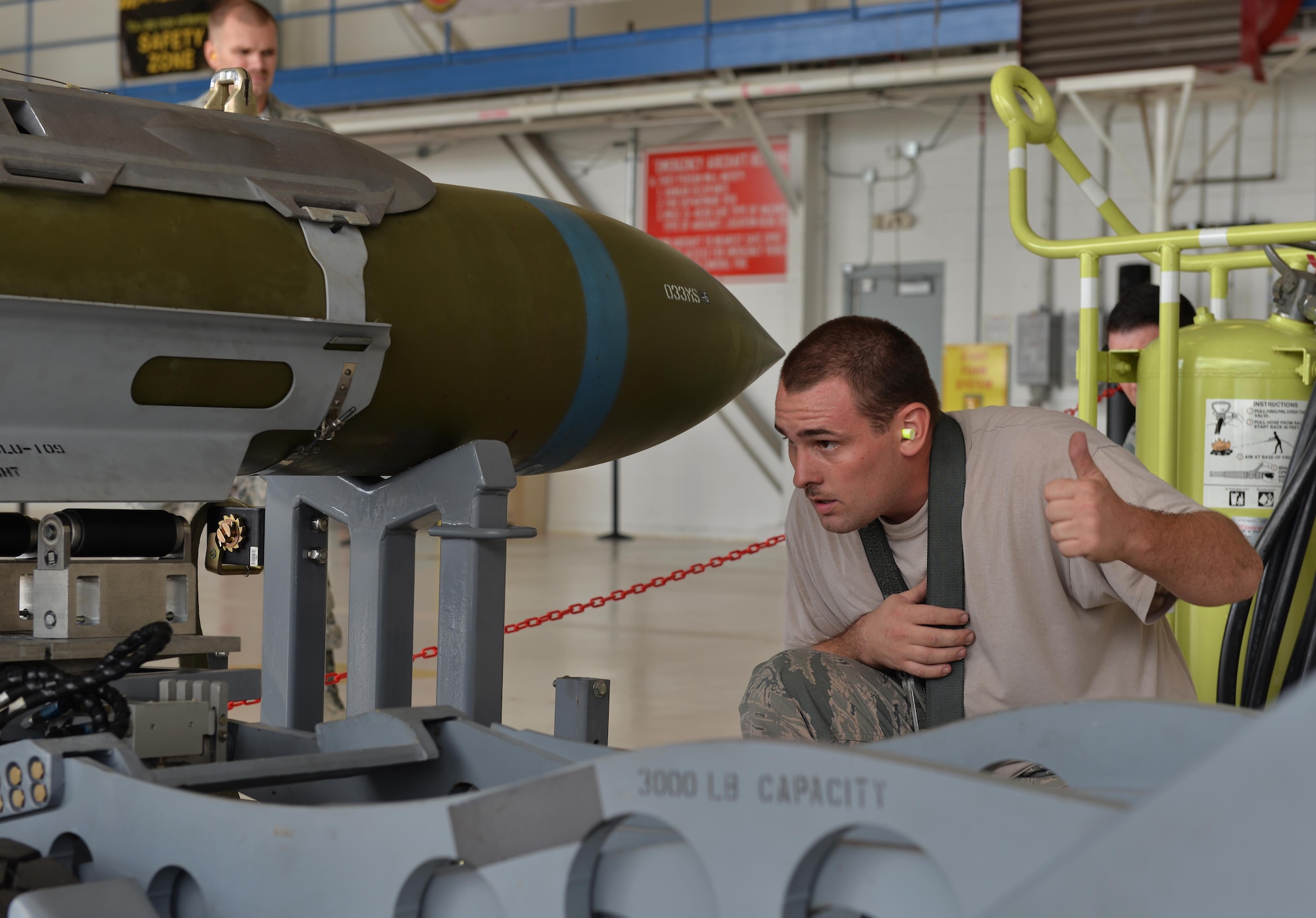 Staff Sgt. Matthew Schlotthauer, 33rd Aircraft Maintenance Squadron weapons load team chief, directs a bomb lift truck to pick-up a missile for a weapons load competition at Eglin Air Force Base, Fla., Sept. 30, 2015. The F-35A Lightning II carries an internal payload to maximize its stealth capability while deployed. (U.S. Air Force Photo/Senior Airman Andrea Posey)