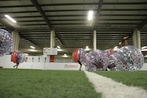 Marines from Recruiting Station Lansing, Mich., collide at the beginning of a “knockerball” soccer game inside one of Lansing’s SoccerZone arenas, Sept. 28, 2015. Marines played the game for a fun, physical training session at the conclusion of a staff non-commissioned officer-in-charge meeting.