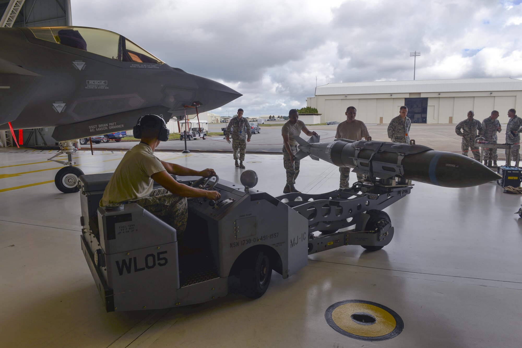 Airmen from the 33rd Aircraft Maintenance Squadron compete in a weapons load competition at Eglin Air Force Base, Fla., Sept. 30, 2015. Load crew members are evaluated on the level of safety, efficiency and speed displayed while loading munitions. (U.S. Air Force Photo/Senior Airman Andrea Posey)