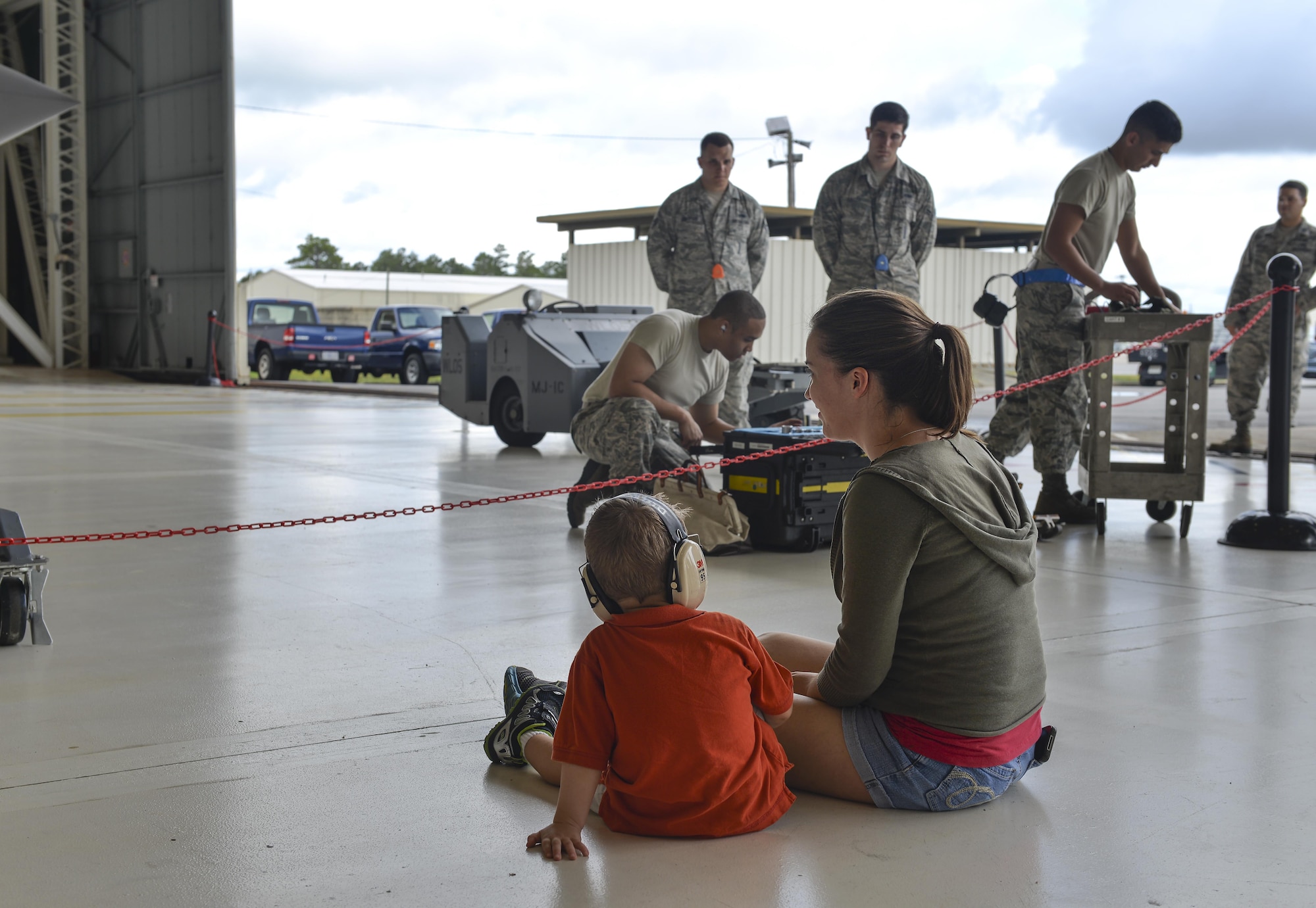 Samantha Egebrecht and her son, Preston, watch a weapons load competition at Eglin Air Force Base, Fla., Sept. 30, 2015. Families and friends came out in support of load crew members participating in the event. (U.S. Air Force Photo/Senior Airman Andrea Posey)