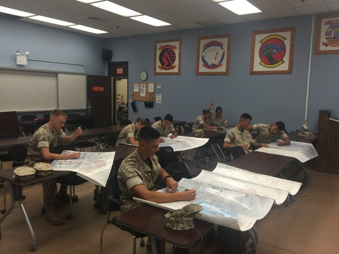 Enlisted students prepare for final plotting exam. This is their last test prior to departing for their first duty station. 