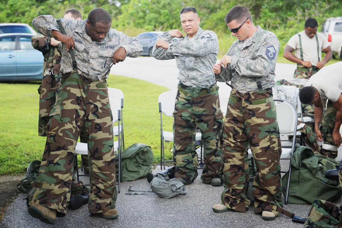 Airmen assigned to the 36th Wing don mission oriented protective posture gear during chemical, biological, radiological and nuclear training Oct. 1, 2015, at Andersen AFB, Guam. Emergency managers teach a CBRN refresher course once a month to Airmen who are preparing for a permanent change of station or deploying to medium or high-threat level duty stations. (U.S. Air Force photo by Senior Airman Joshua Smoot/Released)