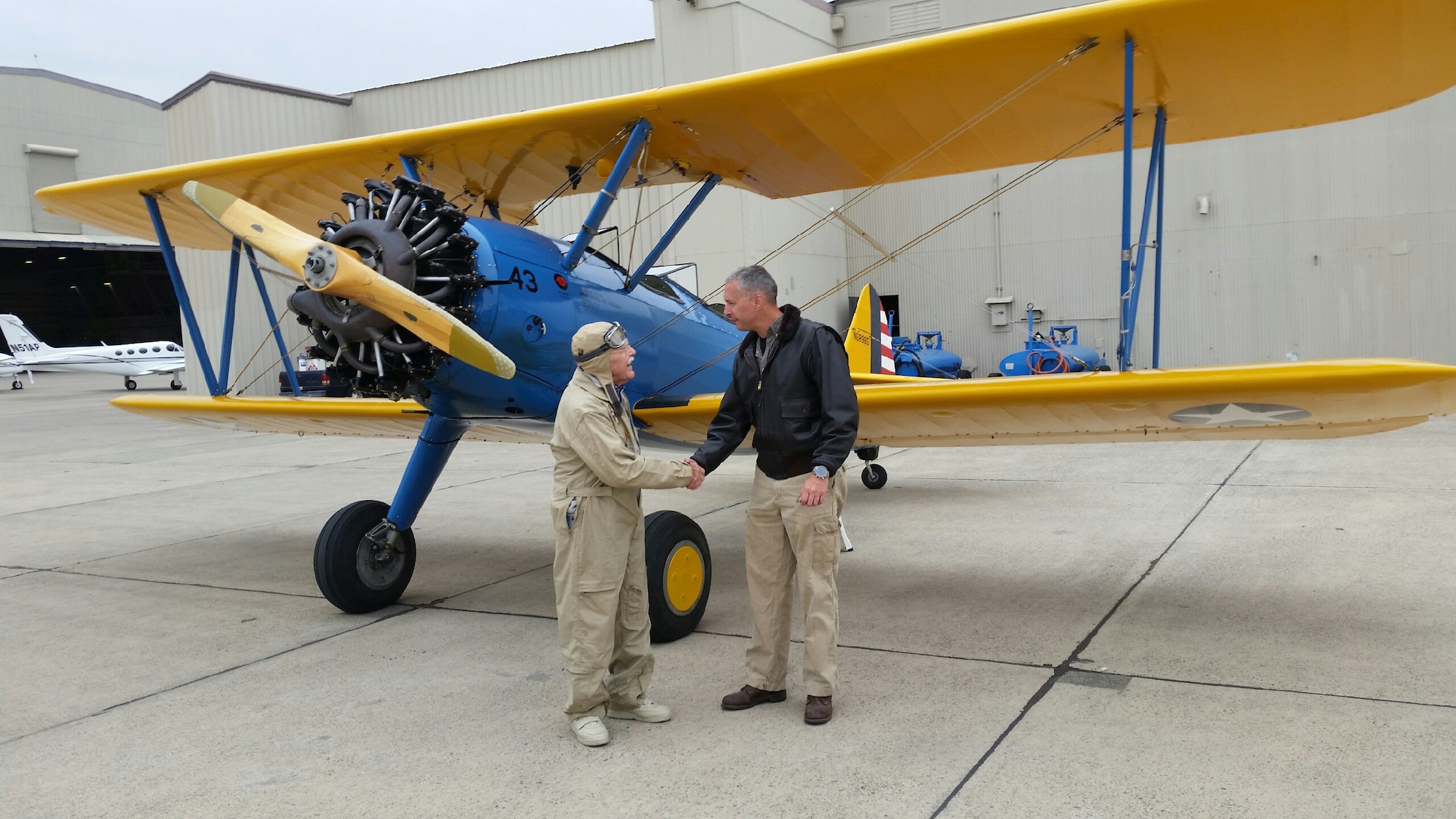 Maynard Nelson, a WWII veteran (left) and Lt. Col. Andrew McVicker, 9th Operations Group deputy commander (right) shake hands after their flight at McClellan Airfield, California, Sept. 30, 2015. McVicker took eight Aerospace Museum of California volunteers who watched over his plane while he was deployed on a flight to show his appreciation.  (U.S. Air Force photo by Staff Sgt. Robert Trujillo)