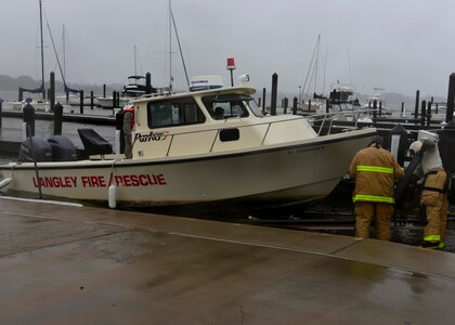 U.S. Air Force Airmen prepare to tow a fire and rescue boat out of the Langley Marina at Langley Air Force Base, Va., Oct. 1, 2015. The boat was moved due to projected tidal surges and potential flooding resulting from Hurricane Joaquin. (U.S. Air Force photo by Airman 1st Class Derek Seifert/ Released)