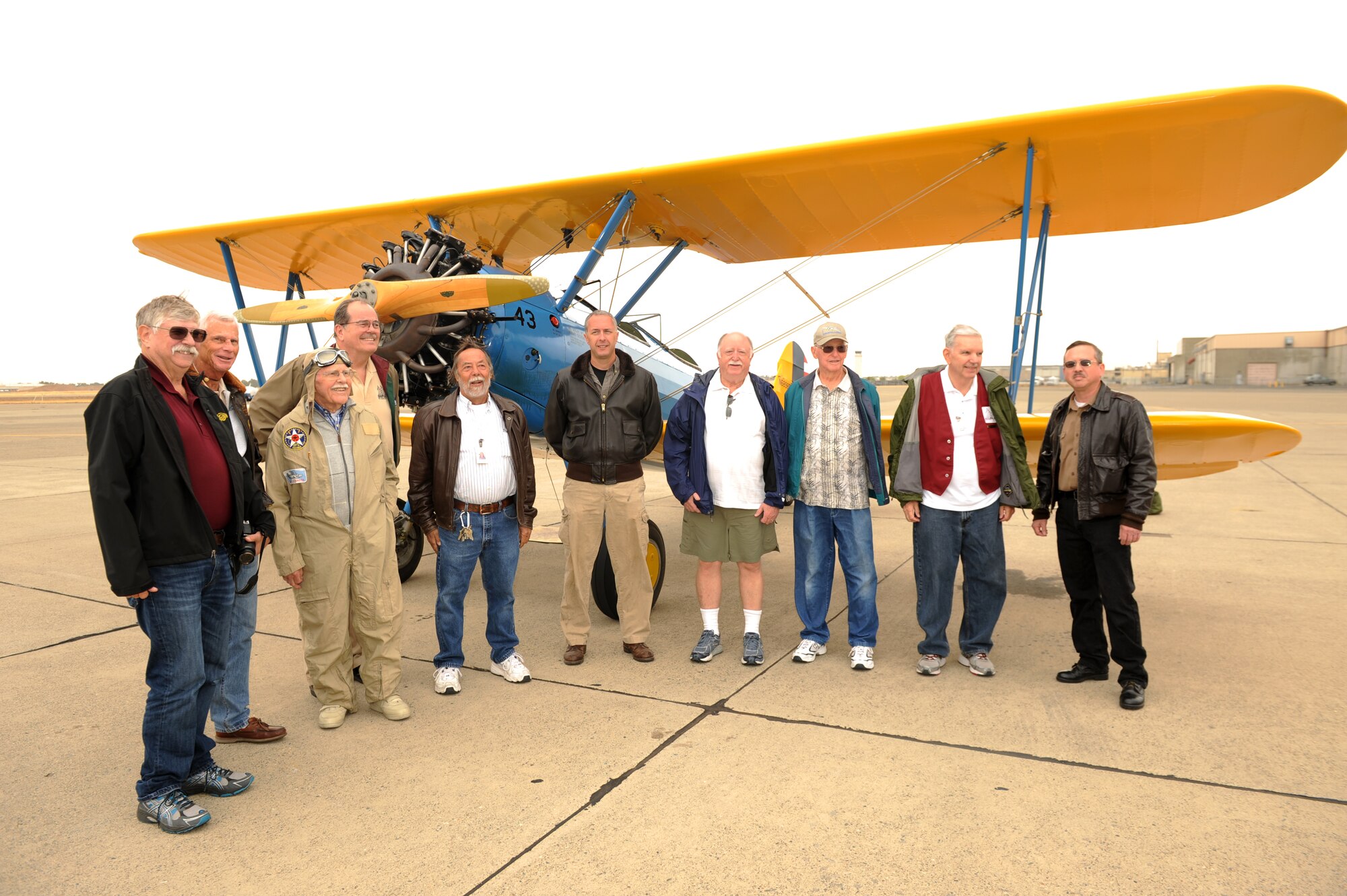 Lt. Col. Andrew McVicker (center), 9th Operations Group deputy commander, and volunteers from the Aerospace Museum of California, pose in front of McVicker’s P-13 Stearman at McClellan Airfield, California, Sept. 30, 2015.  The volunteers watched over McVickers plane while he was deployed and to show his gratitude he took the volunteers on a flight in his P-13 Stearman. (U.S. Air Force photo by Airman 1st Class Jessica B. Nelson)