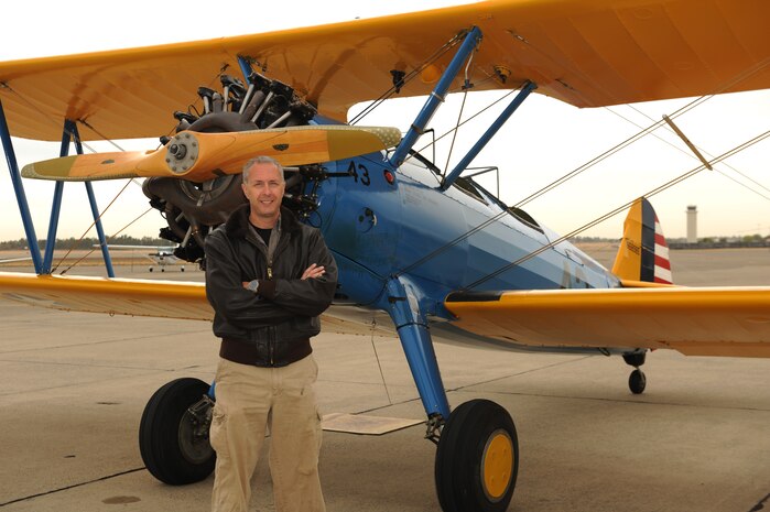 Lt. Col. Andrew McVicker, 9th Operations Group deputy commander poses in front of his P-13 Stearman at McClellan Airfield, California, on Sept. 30, 2015. McVicker flew eight volunteers from the Aerospace Museum of California after they watched his plane while he was deployed. (U.S. Air Force photo by Airman 1st Class Jessica B. Nelson)