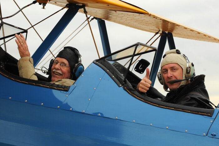 Maynard Nelson, a WWII veteran (left) and Lt. Col. Andrew McVicker, 9th Operations Group deputy commander (right) give a ‘thumbs-up’ as they taxi out to the runway at McClellan Airfield, California, Sept. 30, 2015. McVicker flew eight volunteers from the Aerospace Museum of California after they watched his plane while he was deployed. (U.S. Air Force photo by Airman 1st Class Jessica B. Nelson)