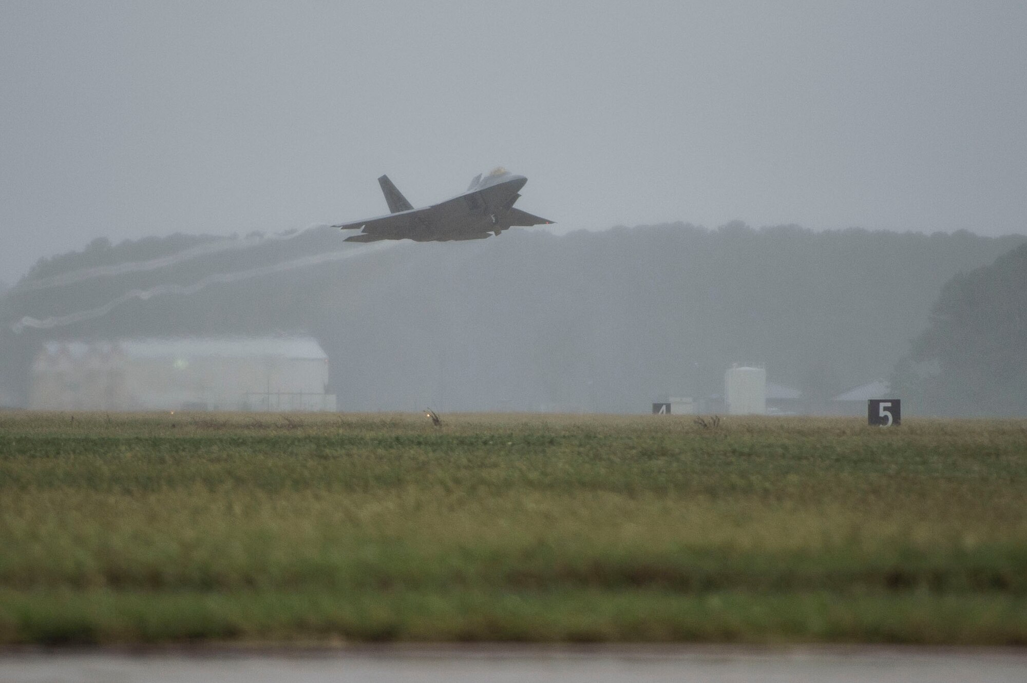 An F-22 Raptor takes off from the runway at Langley Air Force Base, Va., Oct. 1, 2015. Joint Base Langley-Eustis is expected to receive heavy precipitation, high winds, storm surges and flooding as a result of Hurricane Joaquin. (U.S. Air Force photo by Senior Airman Kayla Newman/Released)