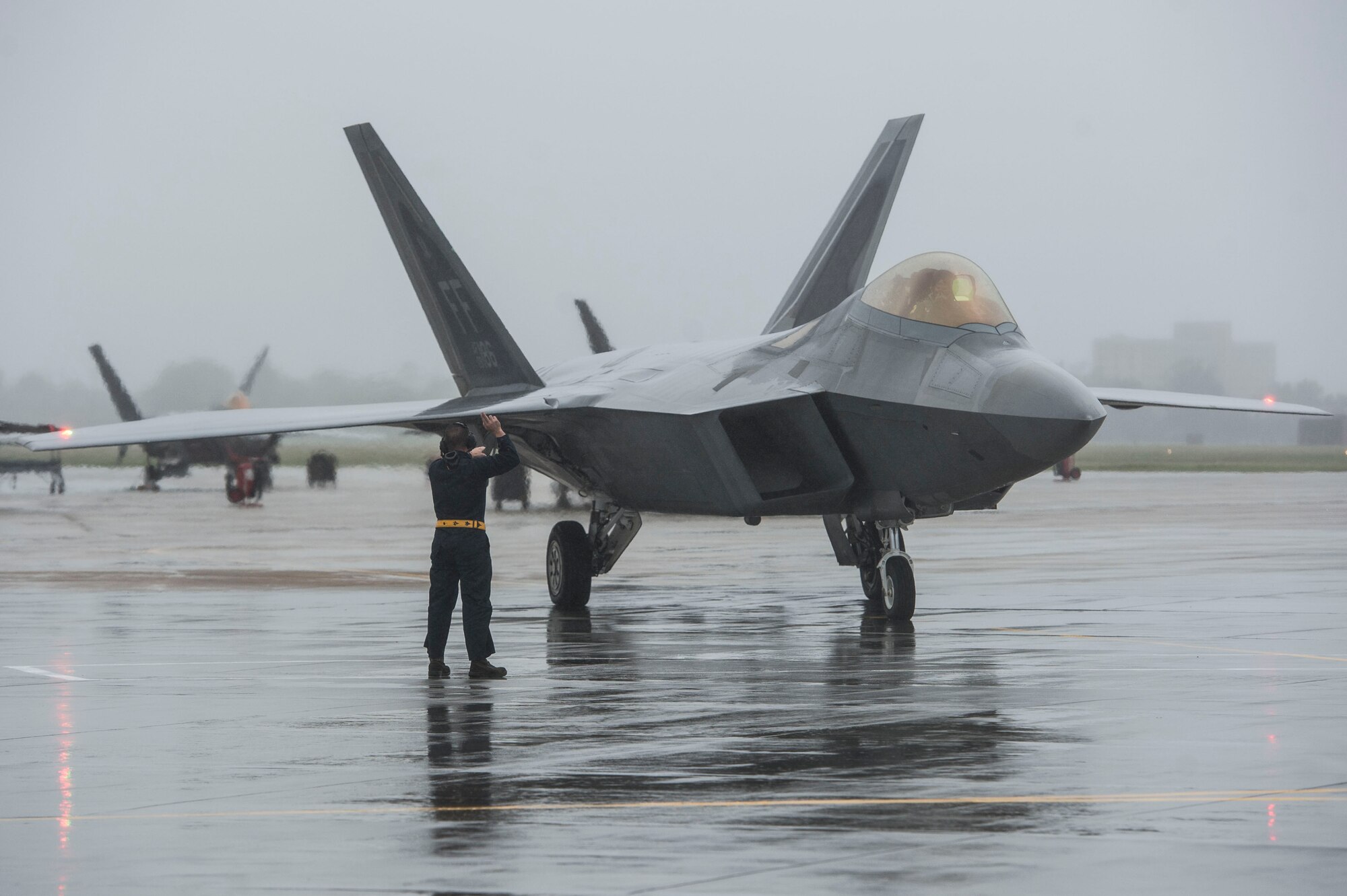 A U.S. Air Force Airman prepares an F-22 Raptor for takeoff at Langley Air Force Base, Va., Oct. 1, 2015. The Raptors and the T-38 Talons assigned to Langley were evacuated in preparation for Hurricane Joaquin. (U.S. Air Force photo by Senior Airman Kayla Newman/Released)