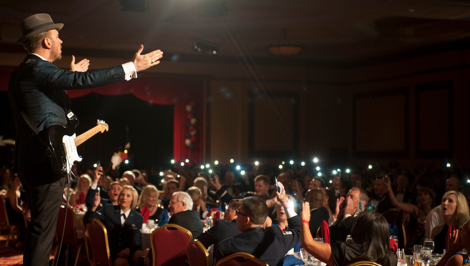 Singer Matt Goss signals to attendees of the 2015 Las Vegas Air Force Ball during his performance at the ceremony inside the South Point Hotel and Casino in Las Vegas, Sept. 26, 2015. Goss performed in front of more than 800 members of Nellis and Creech Air Force Bases, and the Nevada Test and Training Range communities during the event. (U.S. Air Force photo by Staff Sgt. Siuta B. Ika)