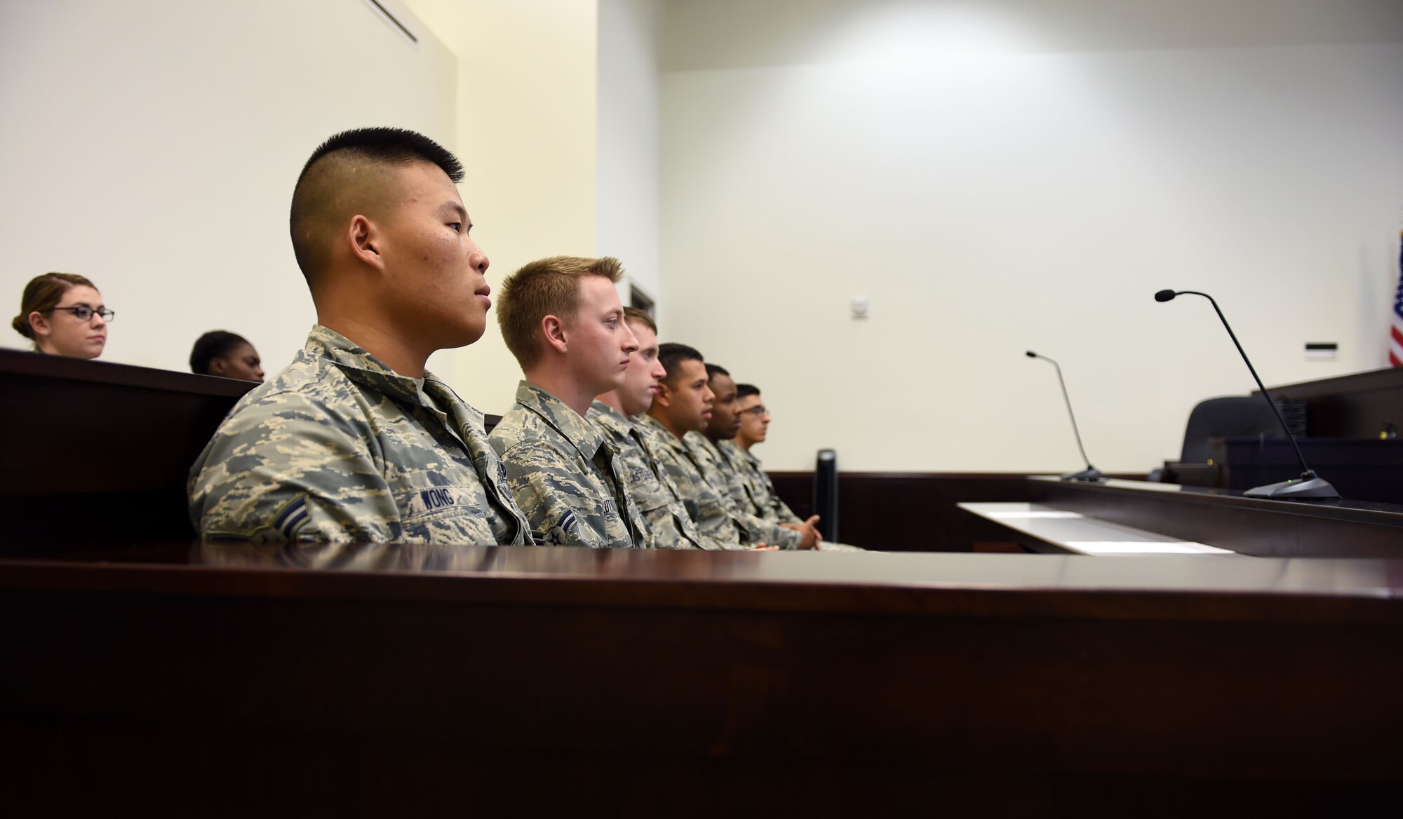 First Term Airman Center Airmen sit in the panel section in the McChord Field courtroom during a mock court-martial on Sept. 29, 2015, Joint Base Lewis-McChord, Wash. The 62nd Airlift Wing legal office presented evidence and testimony identical to a real life sexual assault case scenario.  (Air Force photo/Senior Airman Naomi Griego)