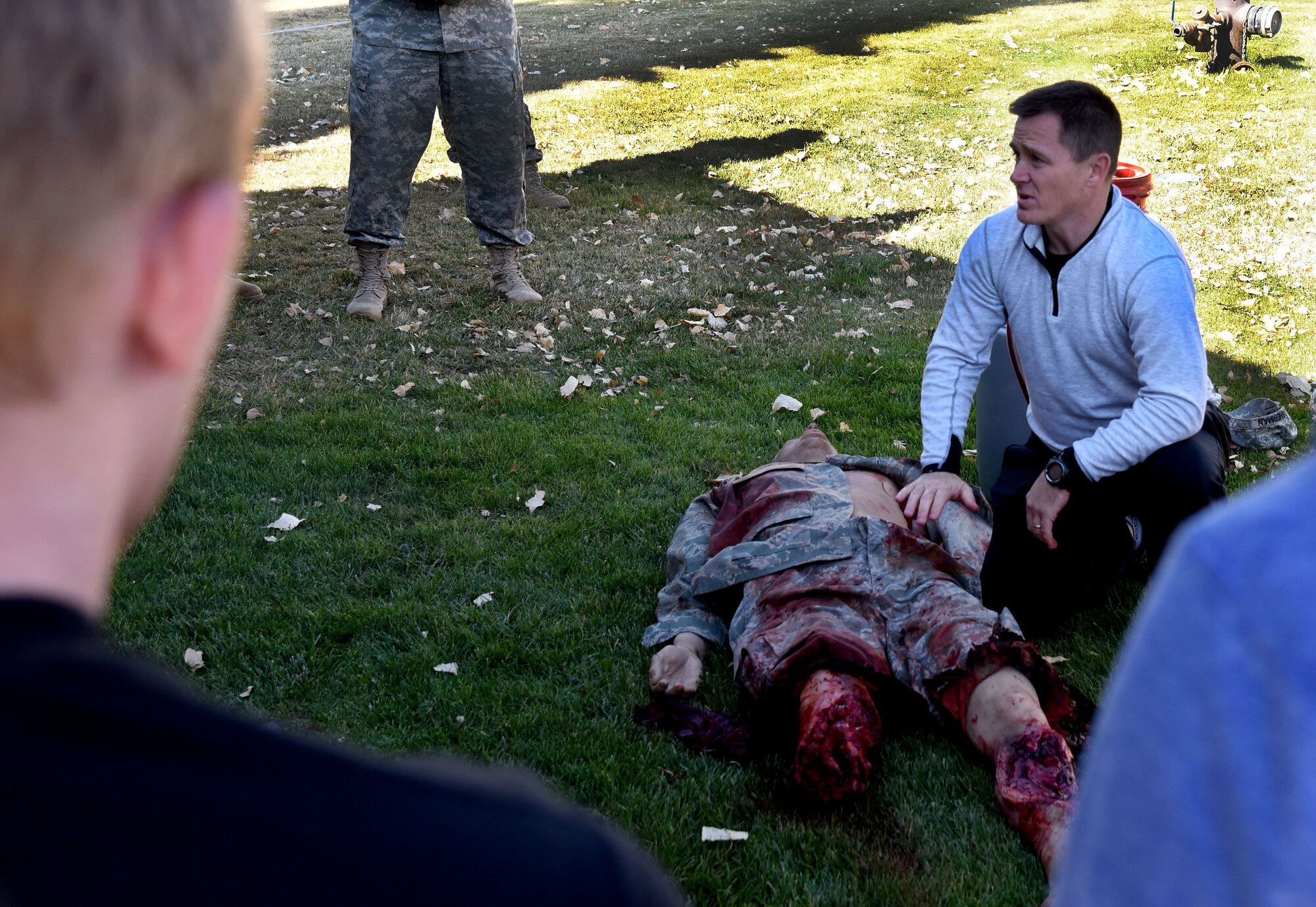 Lt. Col. Steven Ward, 92nd Aerospace Medicine Squadron commander, teaches proper pressure point and tourniquet placement to participants of the AMDS Monster Mash Sept. 30, 2015, at Fairchild Air Force Base, Wash. The AMDS Monster Mash is designed to test teamwork skills, strength and stamina of Airmen. (U.S. Air Force photo/Senior Airman Janelle Patiño)