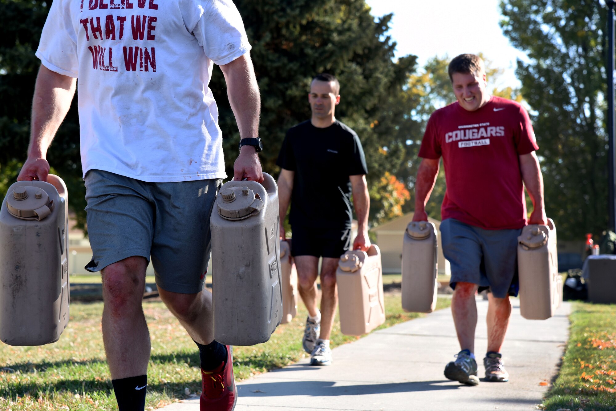 Members of the 92nd Aerospace Medicine Squadron carry containers of water as part of the physical fitness portion during the AMDS Monster Mash Sept. 30, 2015, at Fairchild Air Force Base, Wash. Approximately 30 members from the 92nd AMDS participated. This is Fairchild's first Monster Mash event. (U.S. Air Force photo/Senior Airman Janelle Patiño)