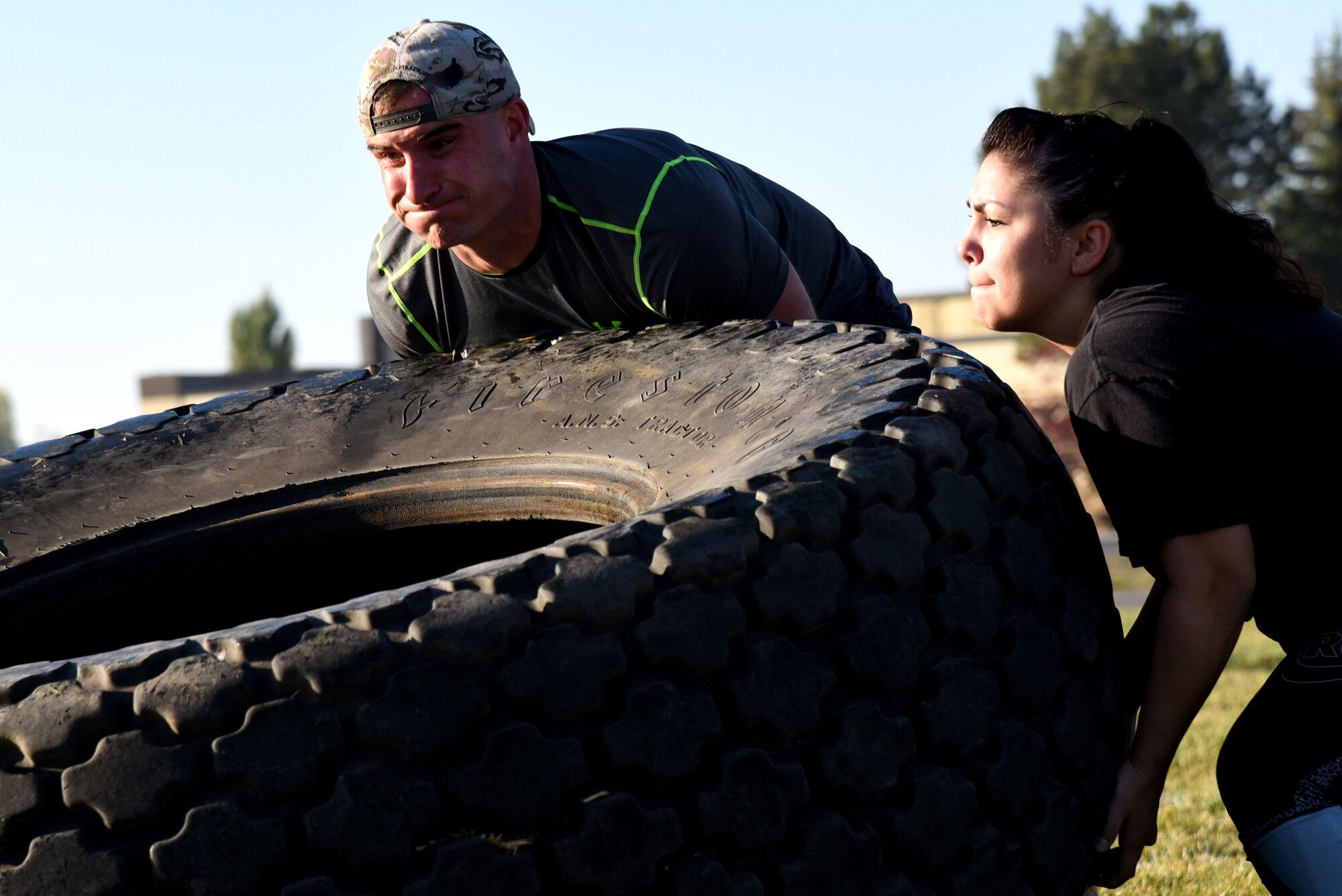 Staff Sgt. Adam Wriglesworth, 92nd Aerospace Medicine Squadron bioenvironmental engineering craftsman, and Staff Sgt. Marissa Reimer, 92nd AMDS base operational medicine cell NCO in charge, "muscle up" the tire flip portion of the AMDS Monster Mash physical fitness station Sept. 30, 2015, at Fairchild Air Force Base, Wash. Approximately 30 members from the 92nd AMDS participated. This is Fairchild's first Monster Mash event. (U.S. Air Force photo/Senior Airman Janelle Patiño)