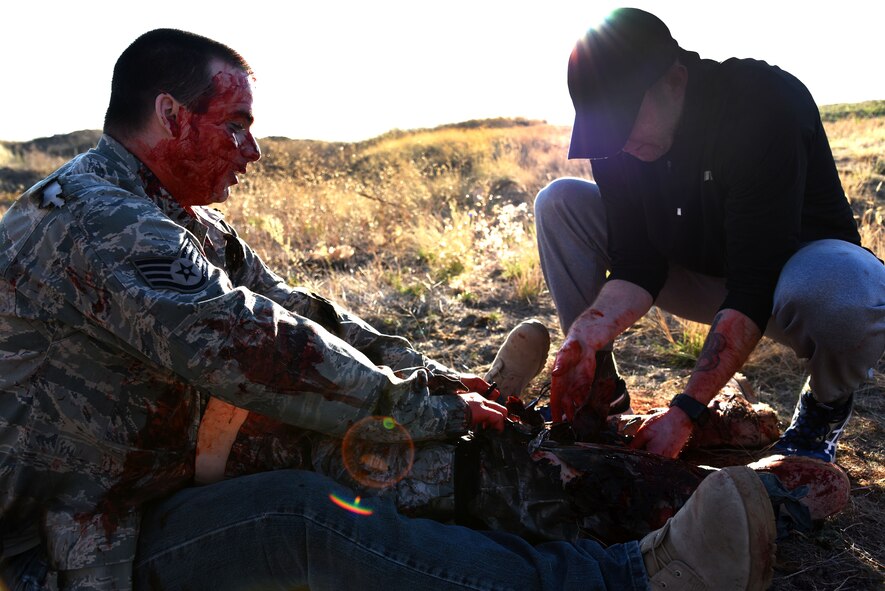 Staff Sgt. Jeremy Davidson, 92nd Aerospace Medicine Squadron public health technician, applies a tourniquet to a simulated wound on a victim at the AMDS Monster Mash medical station Sept. 30, 2015, at Fairchild Air Force Base, Wash. Members from the 396th Combat Support Hospital Army Reserves provided medical training to support the event. (U.S. Air Force photo/Senior Airman Janelle Patiño)