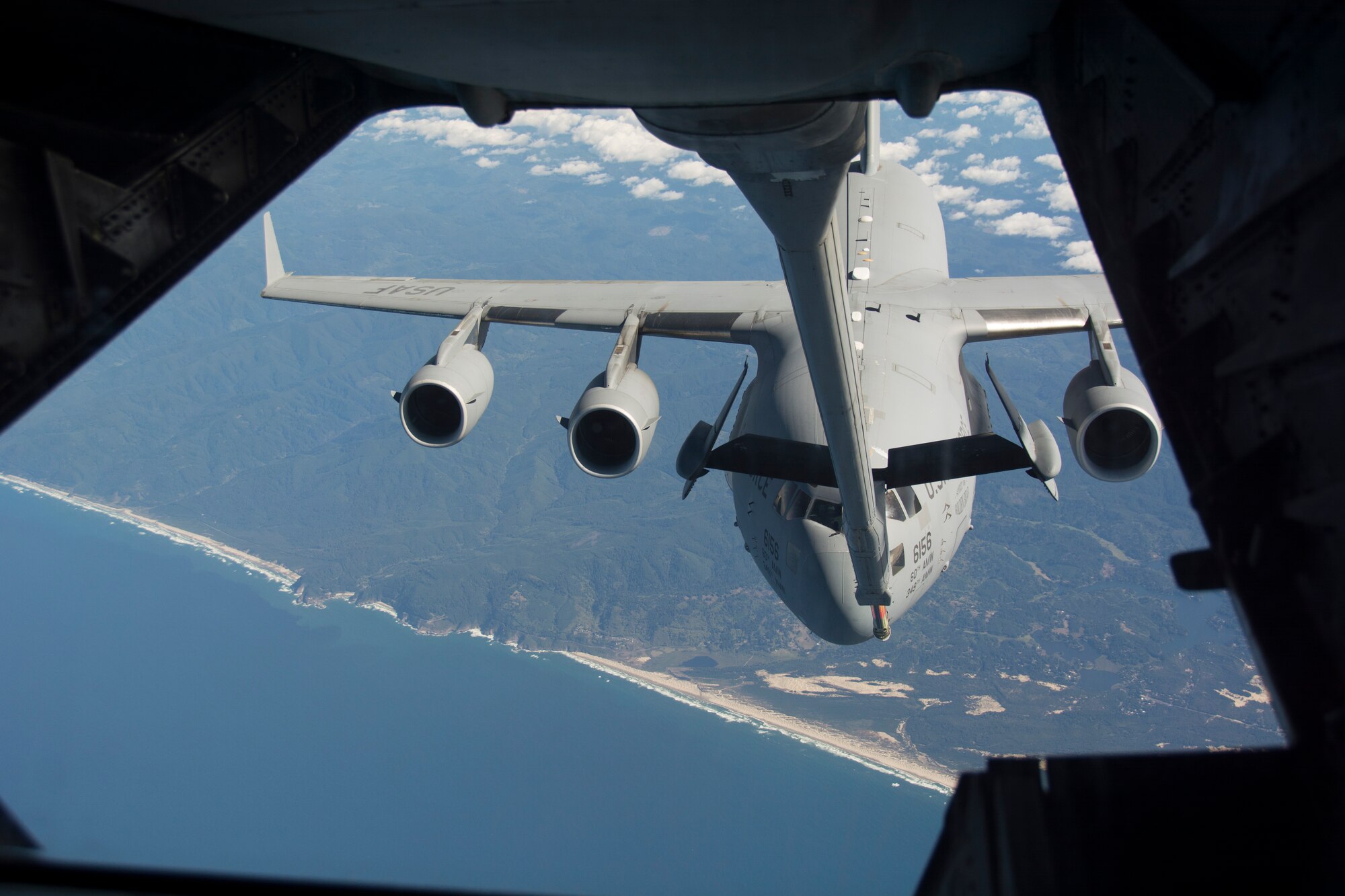 TRAVIS AIR FORCE BASE, Calif. -- A C-17 Globemaster III closes in during aerial refueling with a KC-10 Extender over the northern coast of California, Sept. 26, 2015. Both aircraft, assigned to Travis Air Force Base, Calif., took a part in the 349th Air Mobility Wing's AFSC day. The training provided the Air Force Reserve aircrews additional opportunities to hone their aerial refueling skills. (U.S. Air Force photo/Airman 1st Class Shelby R. Horn)